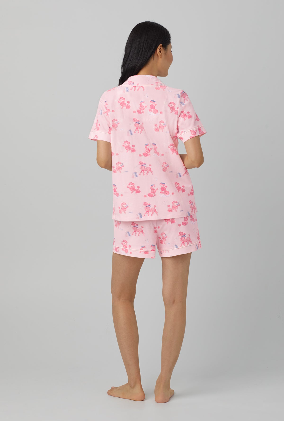 A lady wearing Pink Short Sleeve Classic Short Set Stretch Jersey PJ Set with pampered Poodles print