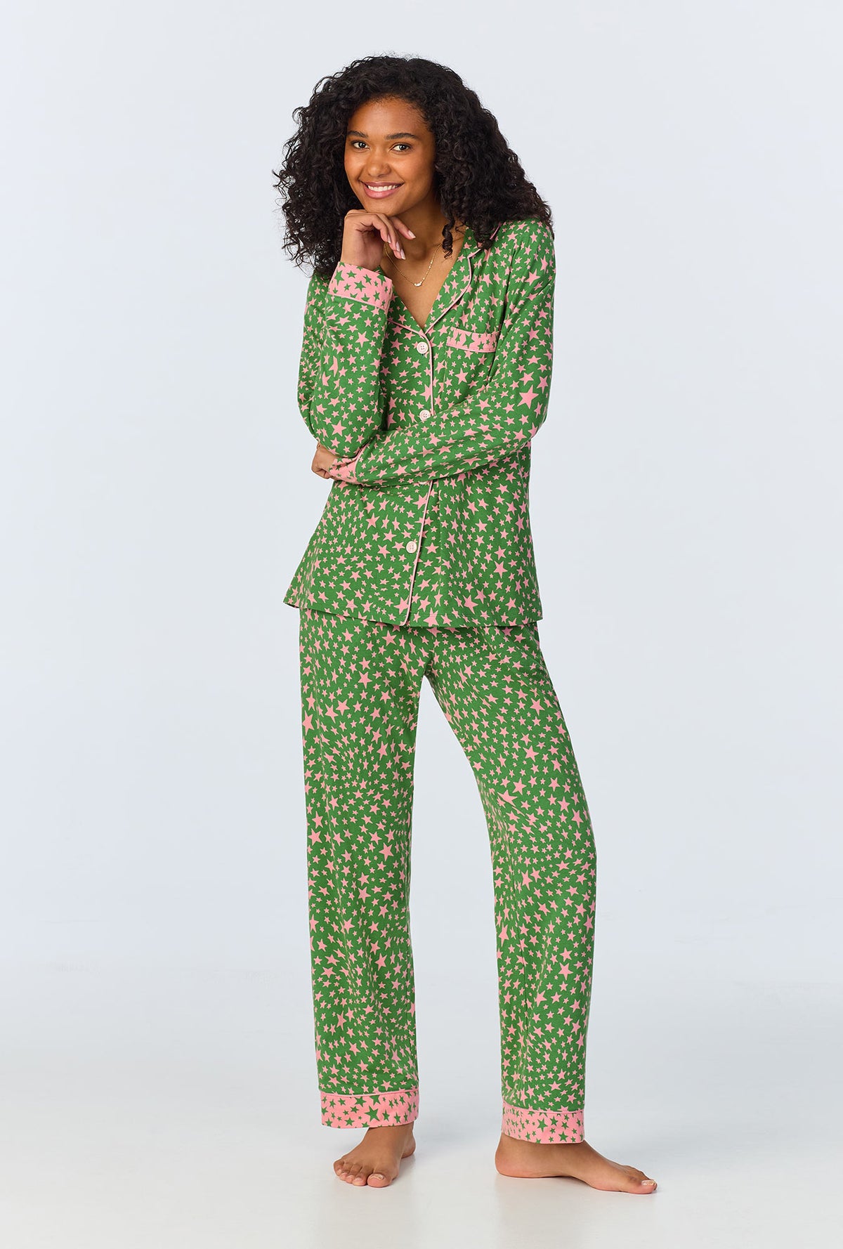 A lady wearing green long sleeve pajama set with green starlight print.