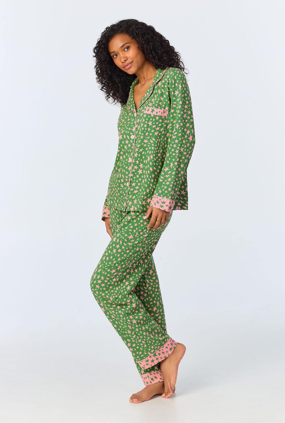 A lady wearing green long sleeve pajama set with green starlight print.