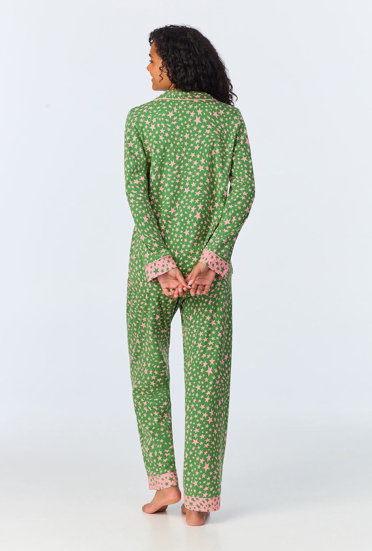 A lady wearing green long sleeve pajama set with green starlight print.