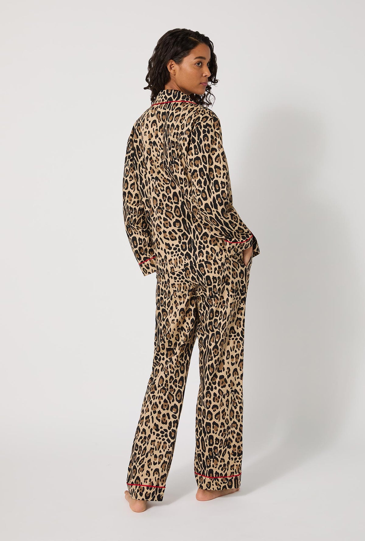 A lady wearing BedHead X Trina Turk Jaguar Stripe Long Sleeve Classic Woven Cotton Poplin Pj Set