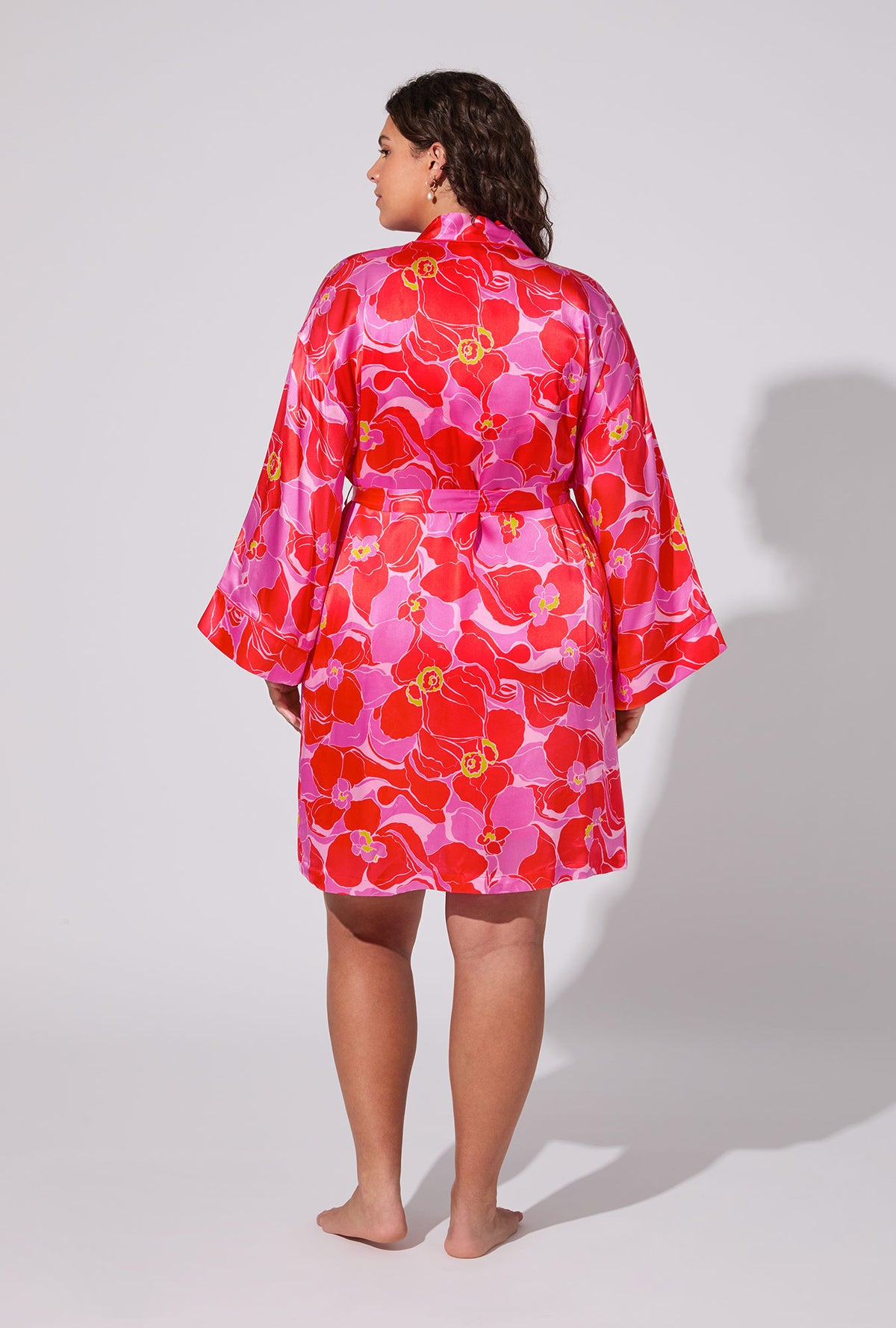 A lady wearing BedHead X Trina Turk Winter Orchids Banded Collar Washable Silk plus Robe