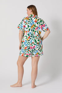 A Lady Wearing Plus Size Jungle Serenade Short Sleeve Classic Shorty Stretch Jersey Pj Set posing with a back view look