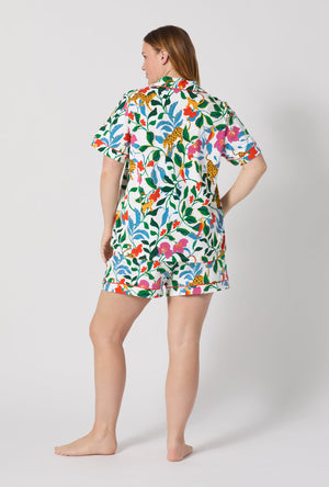 A Lady Wearing Plus Size Jungle Serenade Short Sleeve Classic Shorty Stretch Jersey Pj Set posing with a back view look