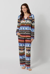 A lady wearing Rifle Paper Co. x BedHead PJs Ski Chalet Long Sleeve Classic Stretch Jersey Pj Set