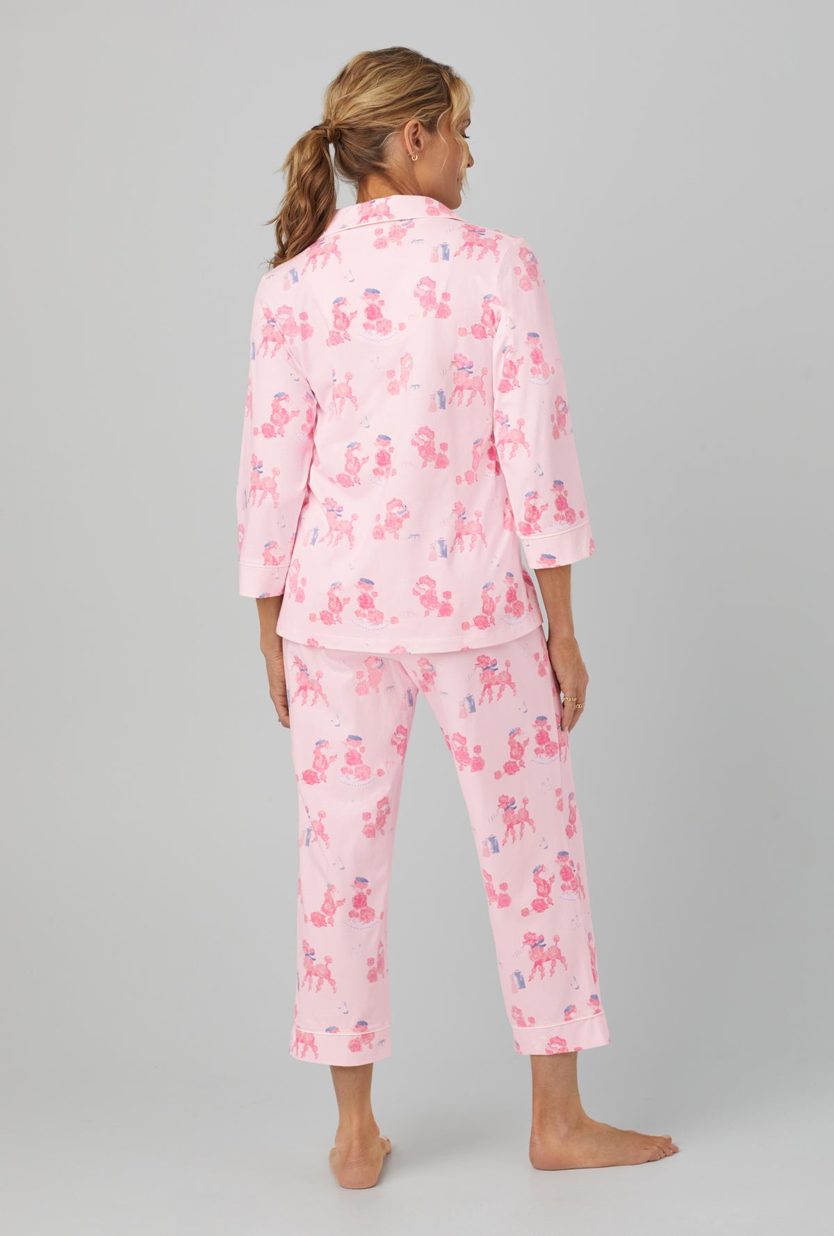 A lady wearing Pink 3/4 Sleeve Classic Stretch Jersey Cropped PJ Set with Pampered Poodles  print