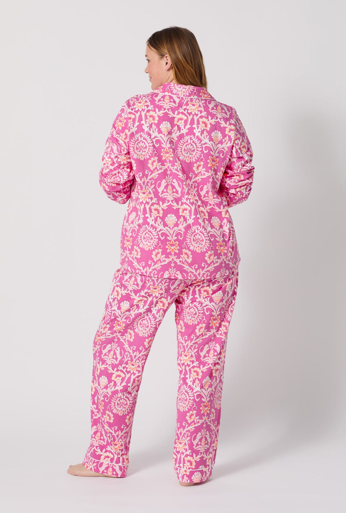 A Lady Wearing Plus Size Luxe Leopard Long Sleeve Classic Stretch Jersey Pj Set facing back while looking to the side