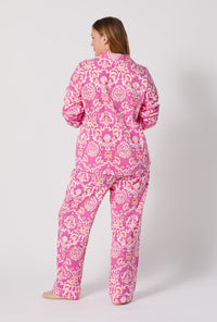 A Lady Wearing Plus Size Luxe Leopard Long Sleeve Classic Stretch Jersey Pj Set facing back while looking to the side
