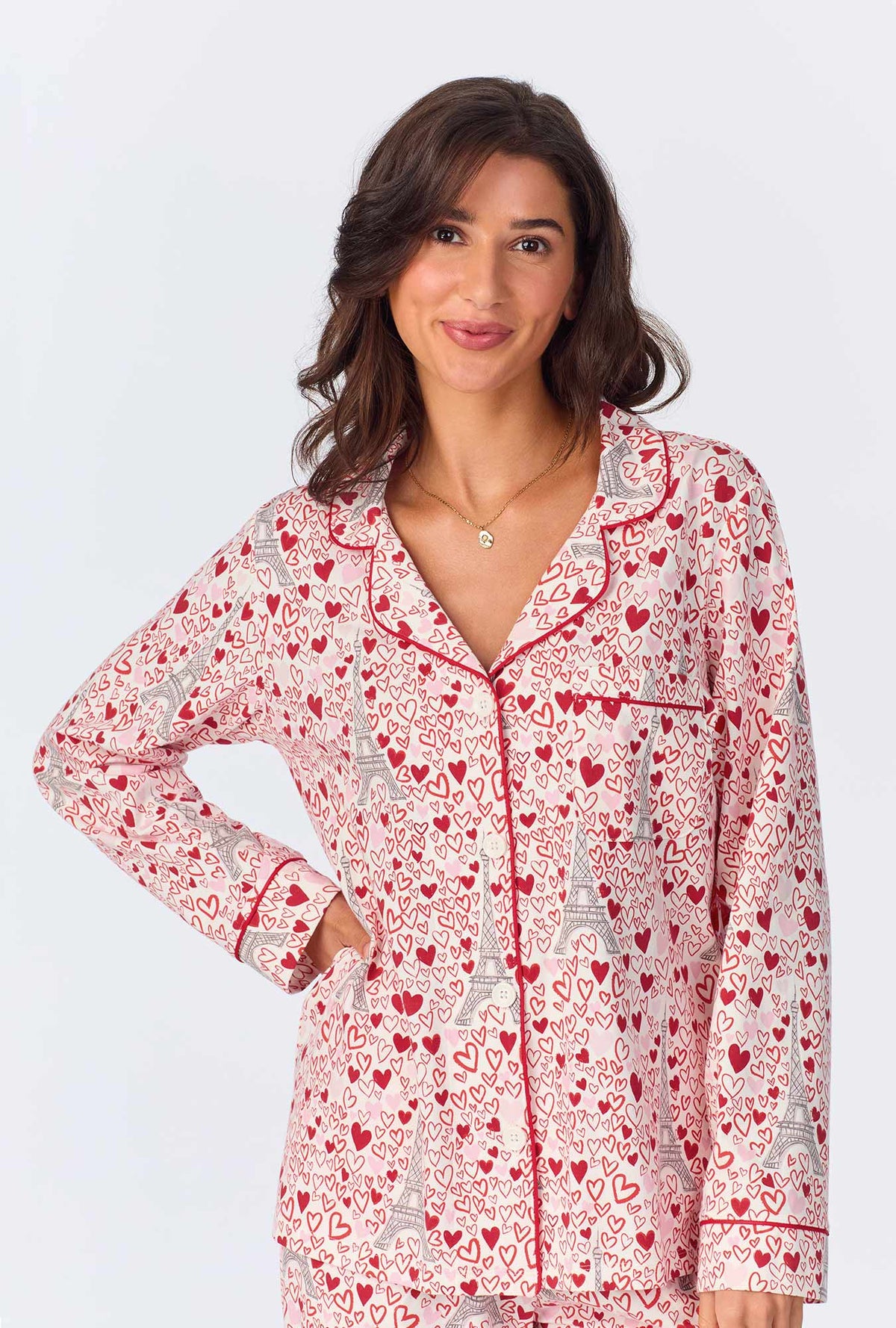 A lady wearing pink long sleeve pajama set with paris je taime print.