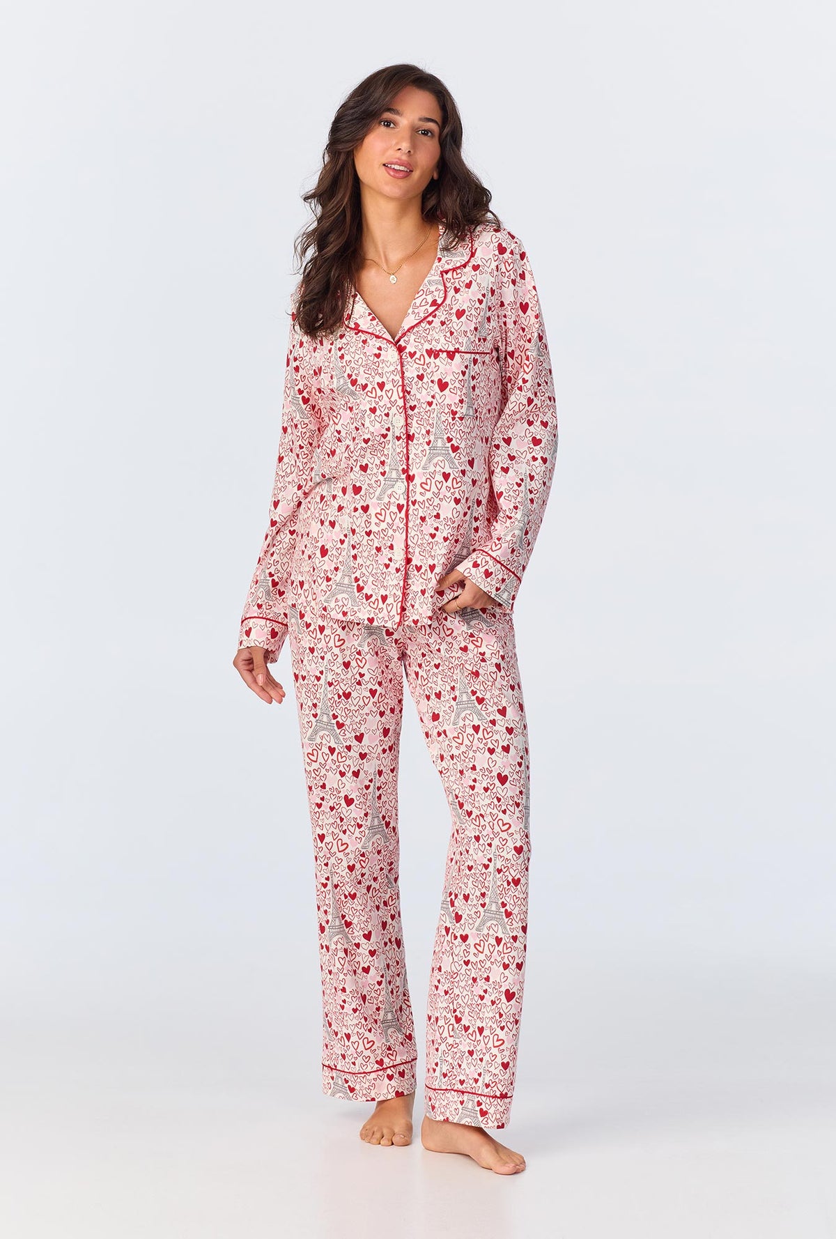 A lady wearing pink long sleeve pajama set with paris je taime print.