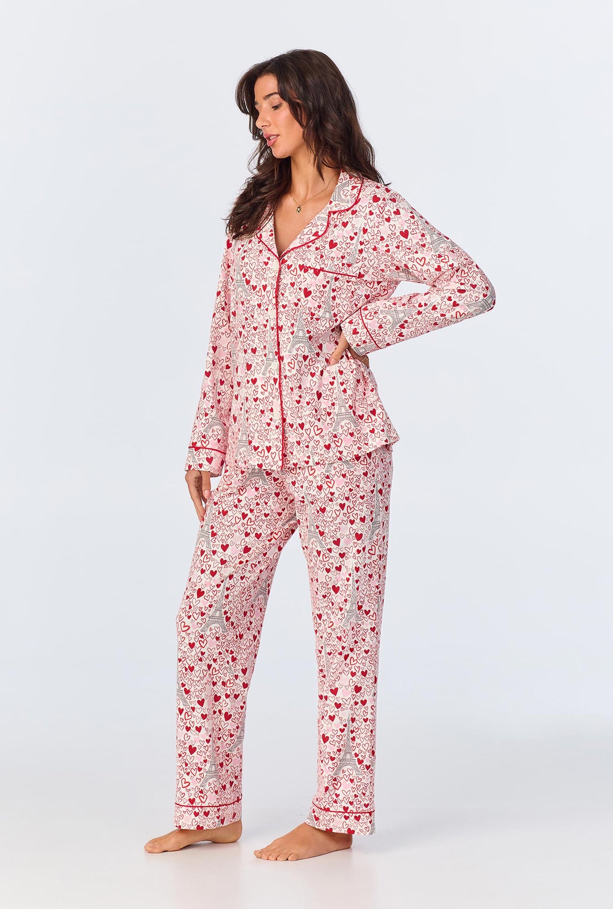 A lady wearing pink long sleeve pajama set with paris je taime print.