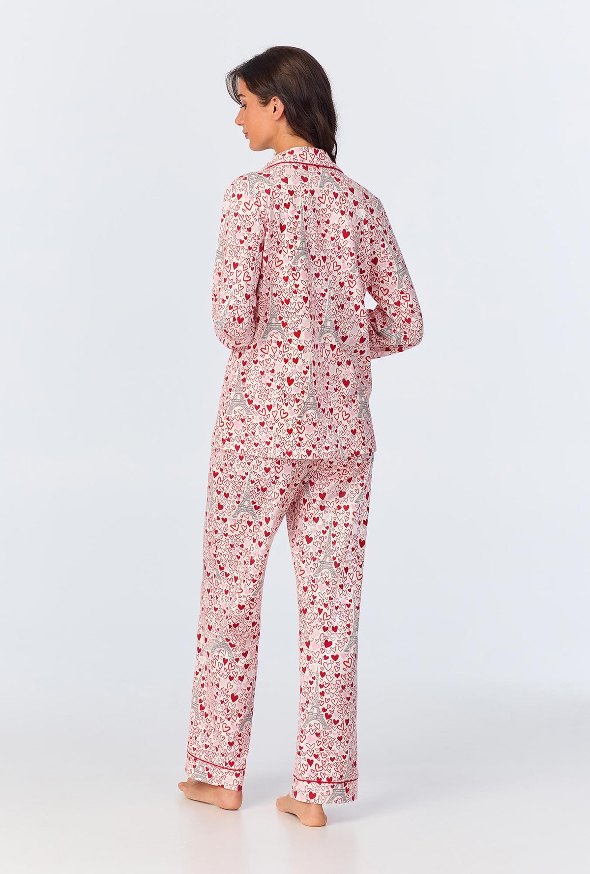 A lady wearing pink long sleeve pajama set with paris je taime print.