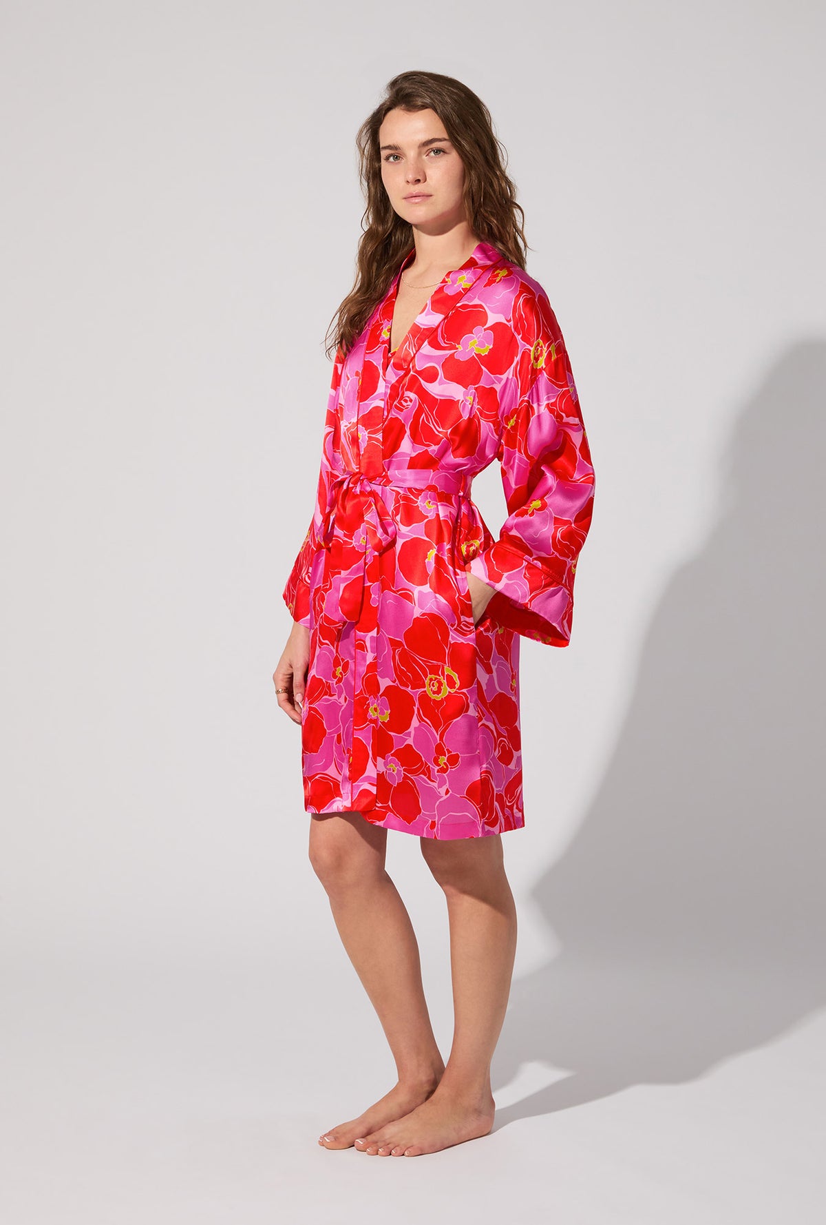 A lady wearing BedHead X Trina Turk Winter Orchids Banded Collar Washable Silk Robe