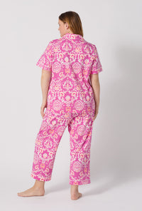 A Lady Wearing Plus Size Luxe Leopard Short Sleeve Classic Stretch Jersey Cropped Pj Set posing with a back view