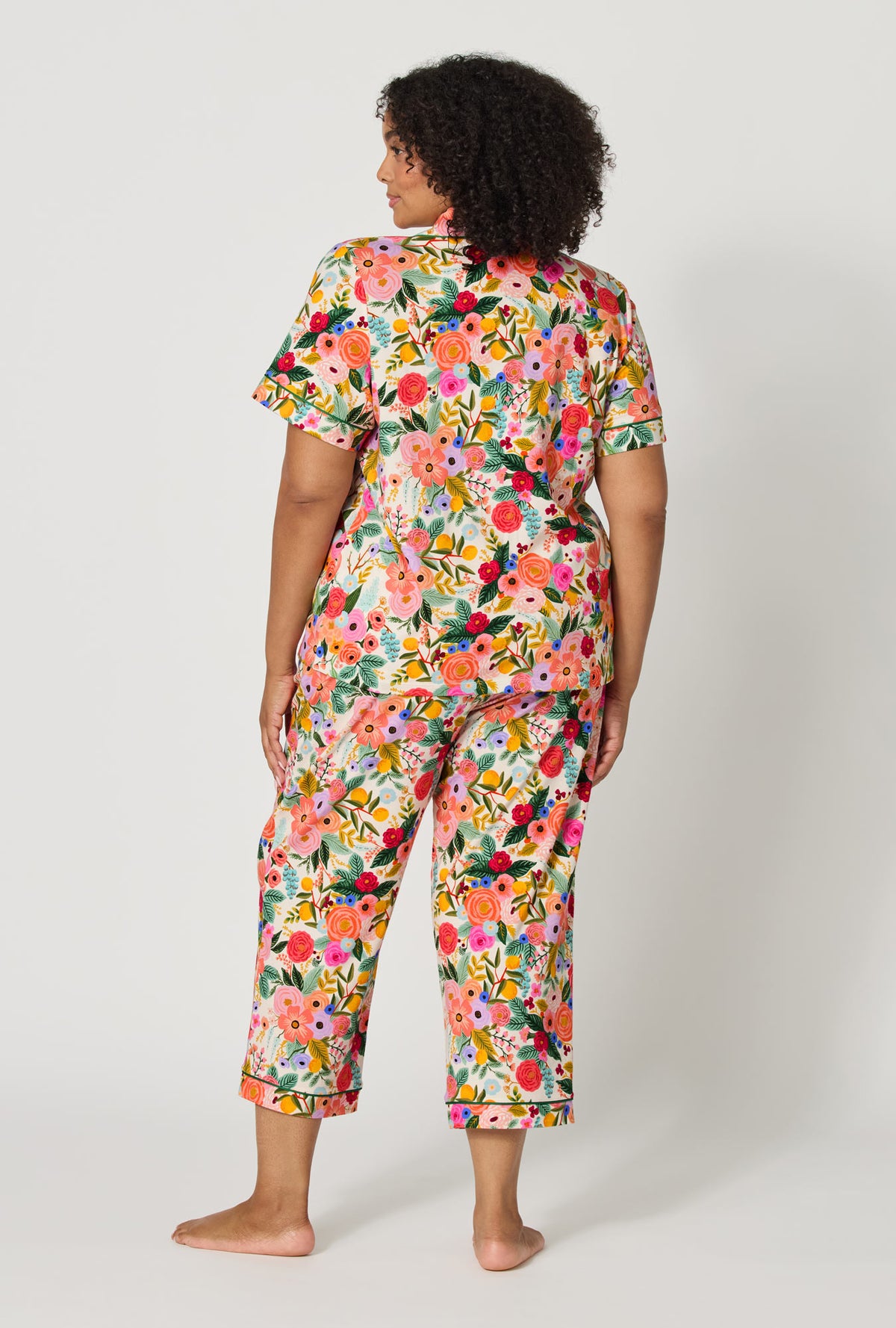 A lady wearing plus size Rifle Paper Co. x BedHead PJs Garden Party Short Sleeve Classic Stretch Jersey Cropped Pj Set back view