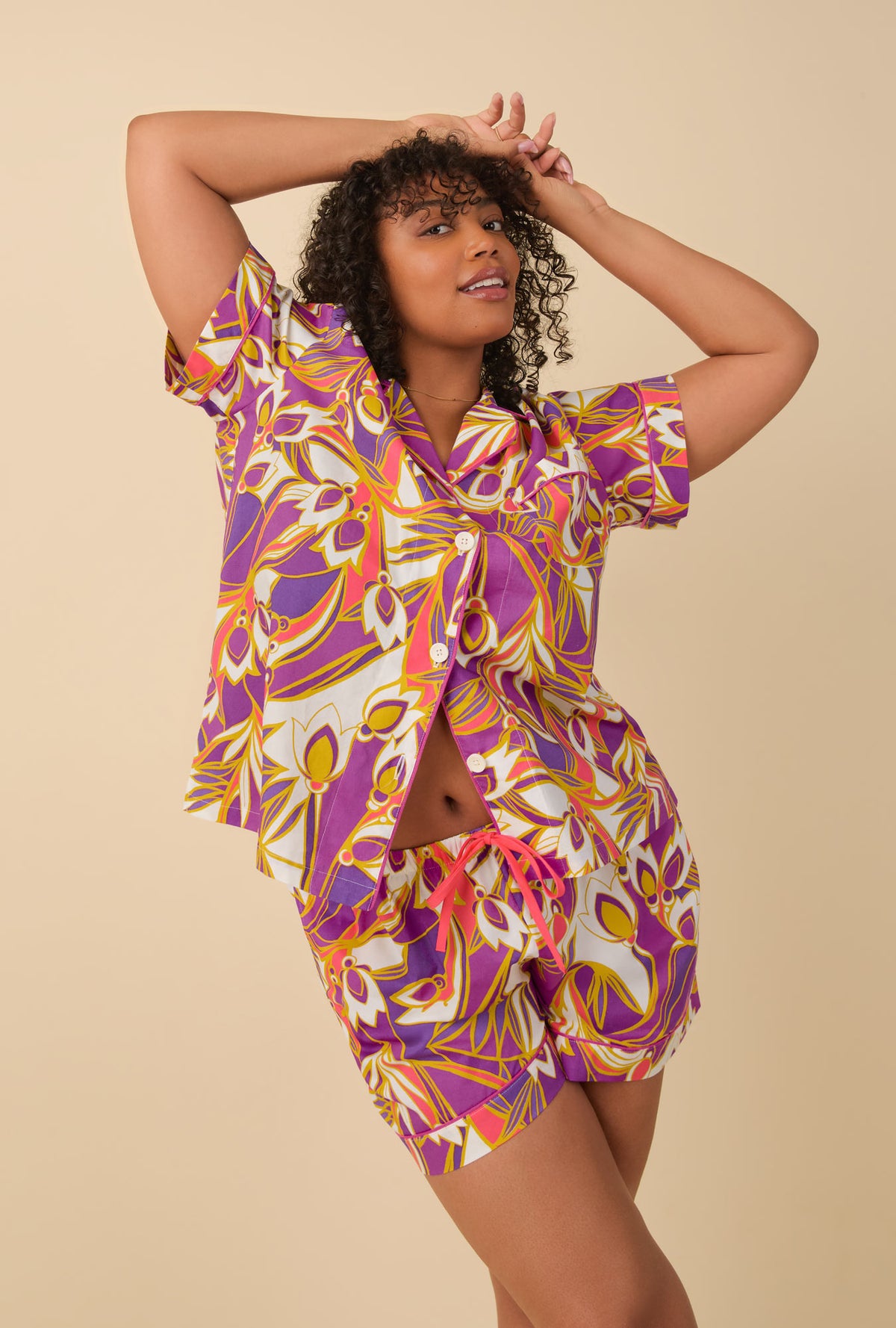 A lady wearing multi color short sleeve classic shorty woven cotton poplin pj set with sengal garden print.