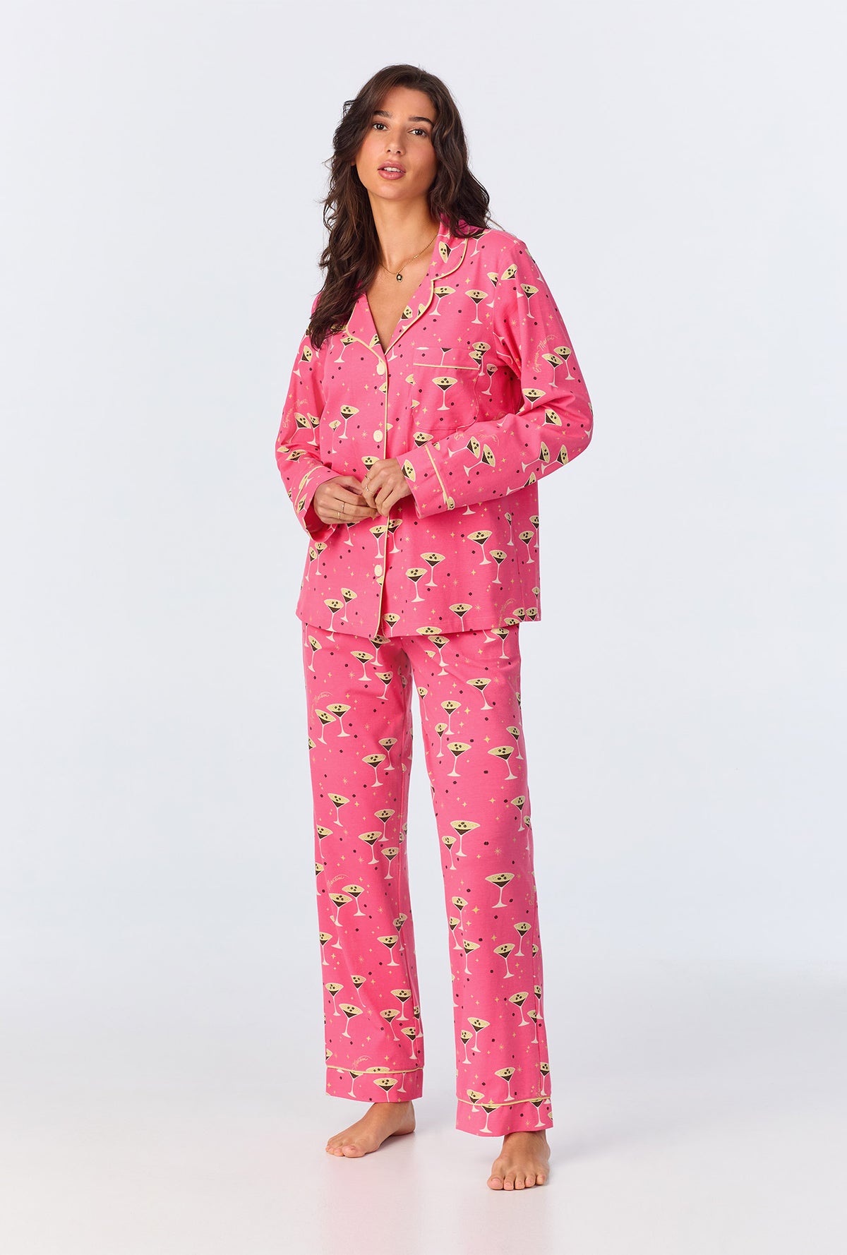 A lady wearing pink long sleeve pajama set with espresso print.