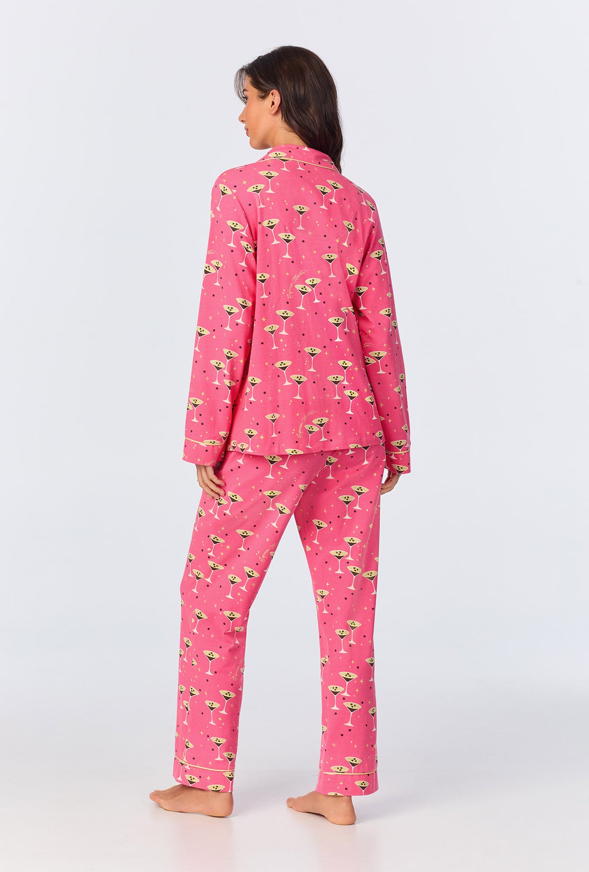 A lady wearing pink long sleeve pajama set with espresso print.