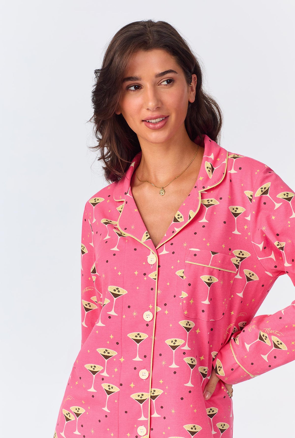 A lady wearing pink long sleeve pajama set with espresso print.