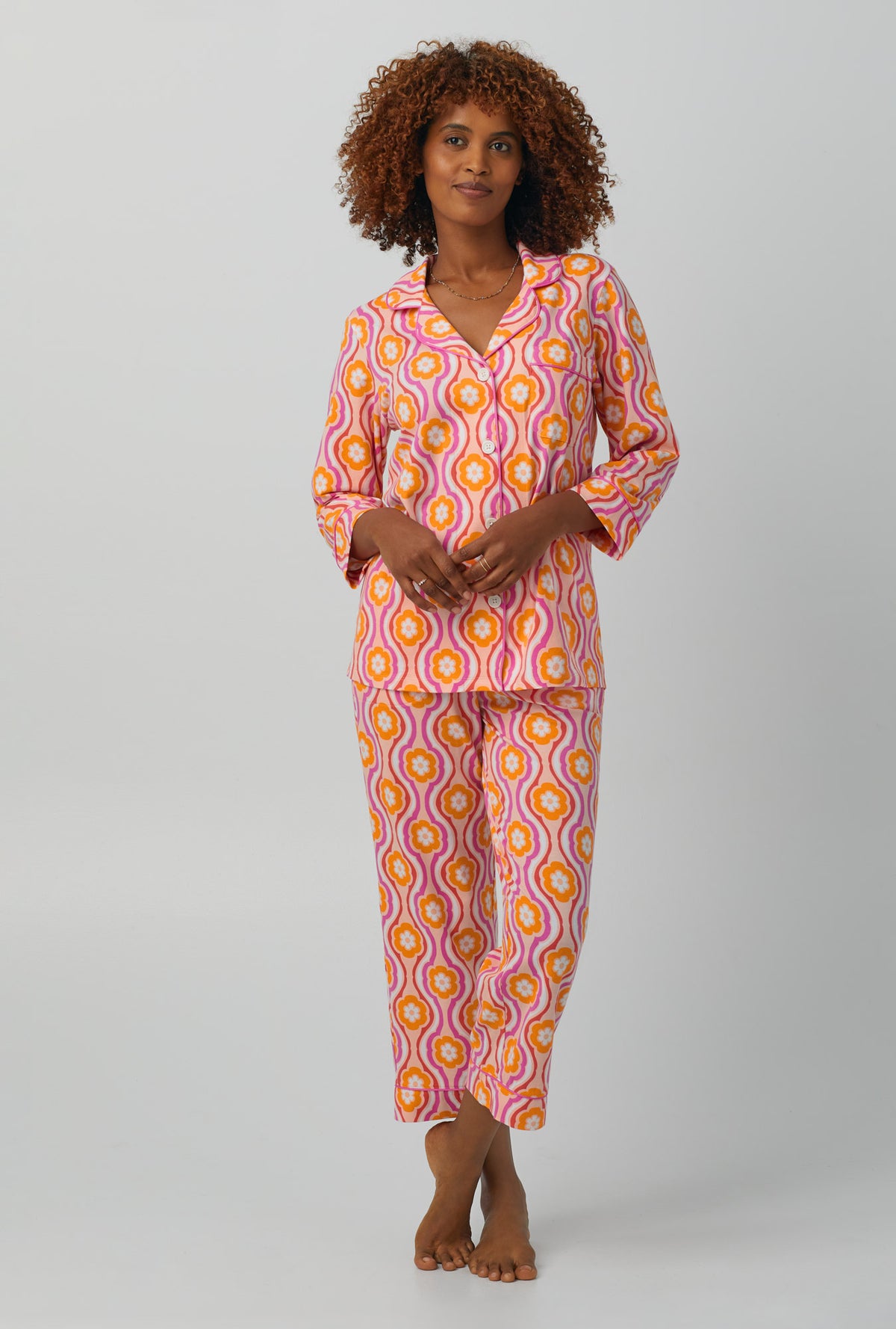 A lady wearing 3/4 Sleeve Classic Stretch Jersey Cropped PJ Set with flower swirl print