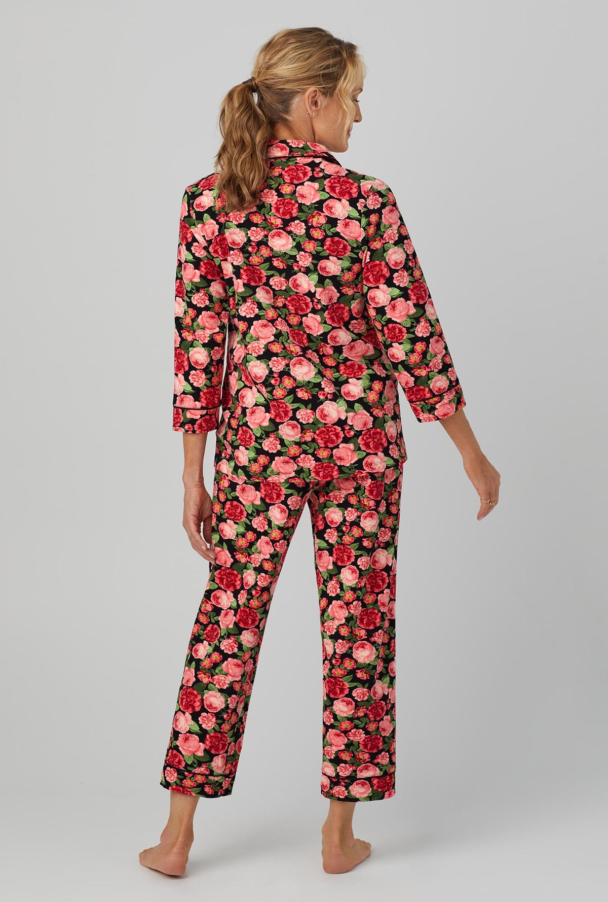 A lady wearing 3/4 Sleeve Classic Stretch Jersey Cropped PJ Set with Roses are Red print