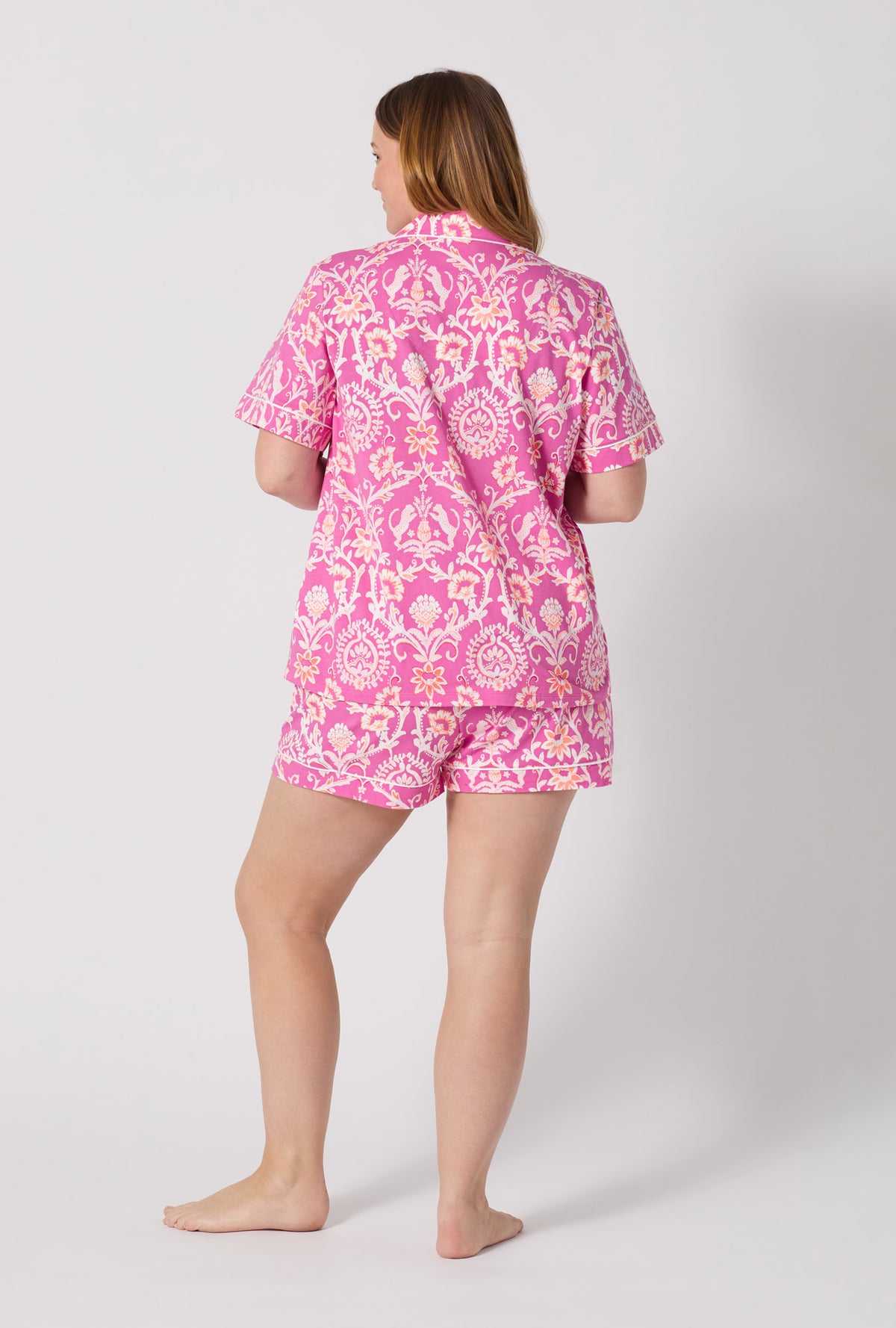 A Lady Wearing Plus Size Luxe Leopard Short Sleeve Classic Shorty Stretch Jersey Pj Set posing with a back view