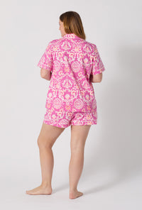 A Lady Wearing Plus Size Luxe Leopard Short Sleeve Classic Shorty Stretch Jersey Pj Set posing with a back view