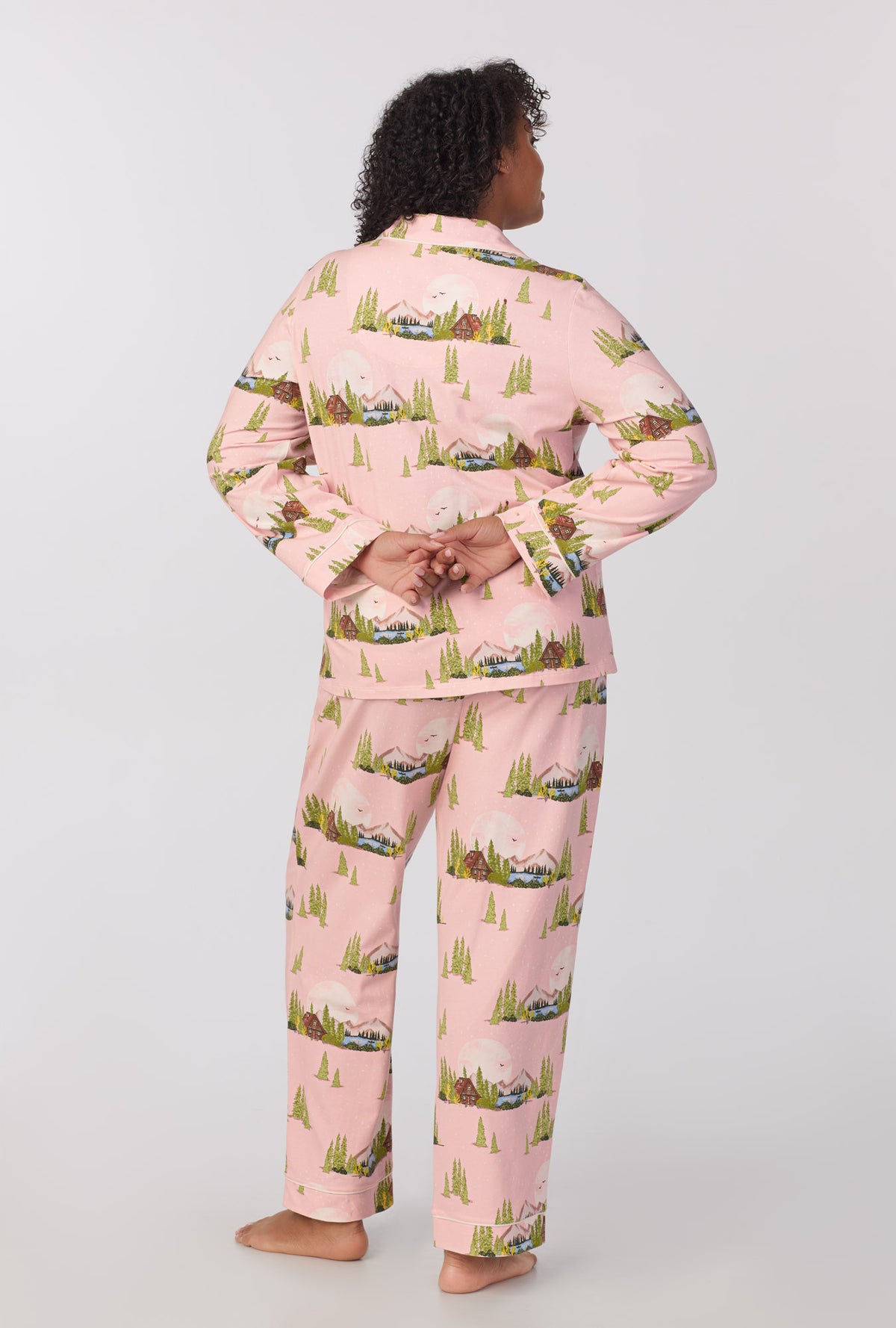 A lady wearing plus size Long Sleeve Classic Stretch Jersey PJ Set with Pine Lake print