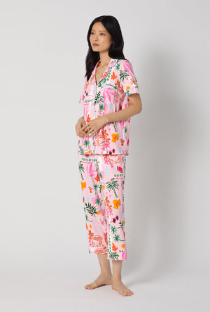 A Lady Wearing Tropical Daydream Short Sleeve Classic Stretch Jersey Cropped Pj Set posing in a side angle view