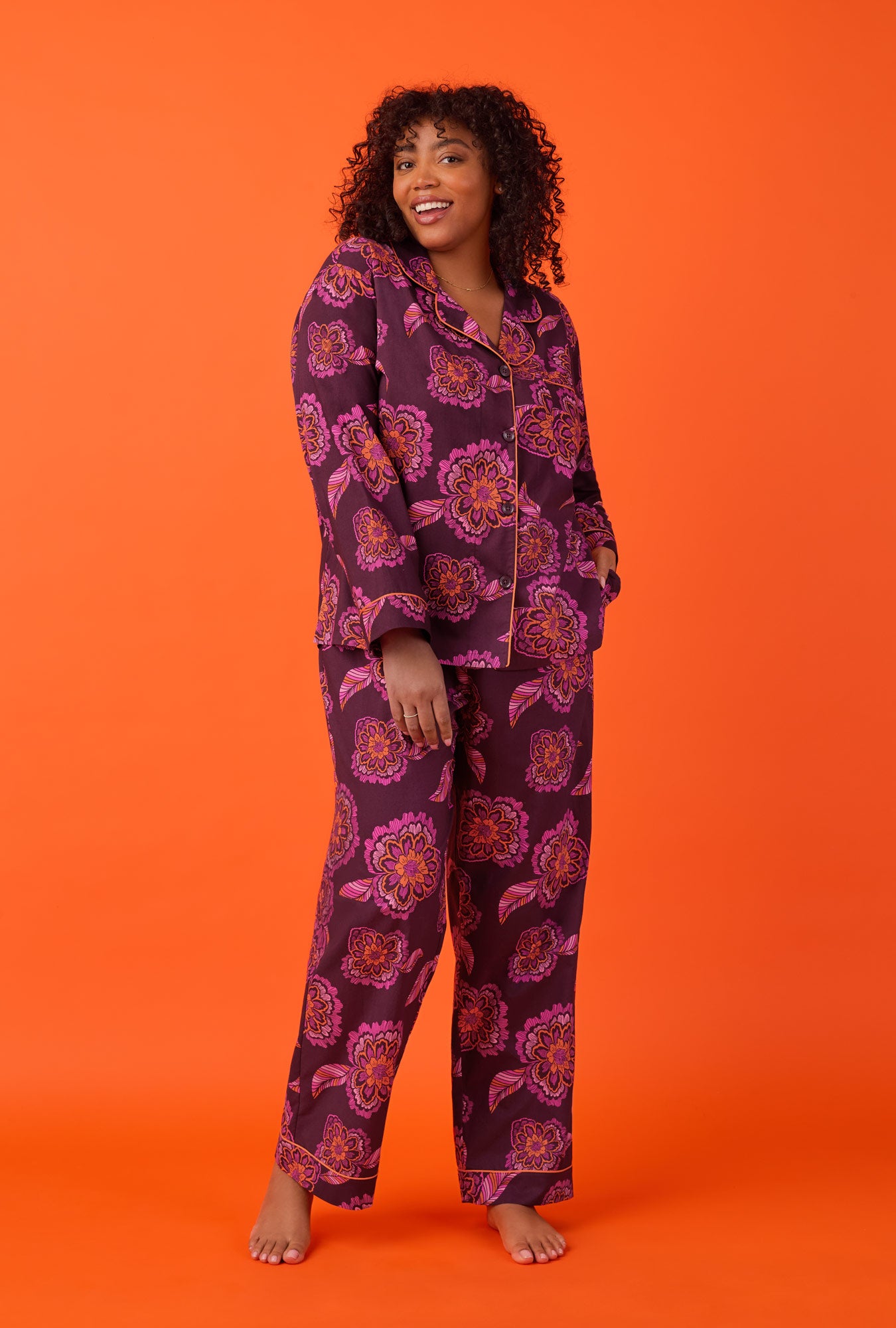 A lady wearing long Sleeve Classic Woven Cotton Poplin PJ Set with African Floral print