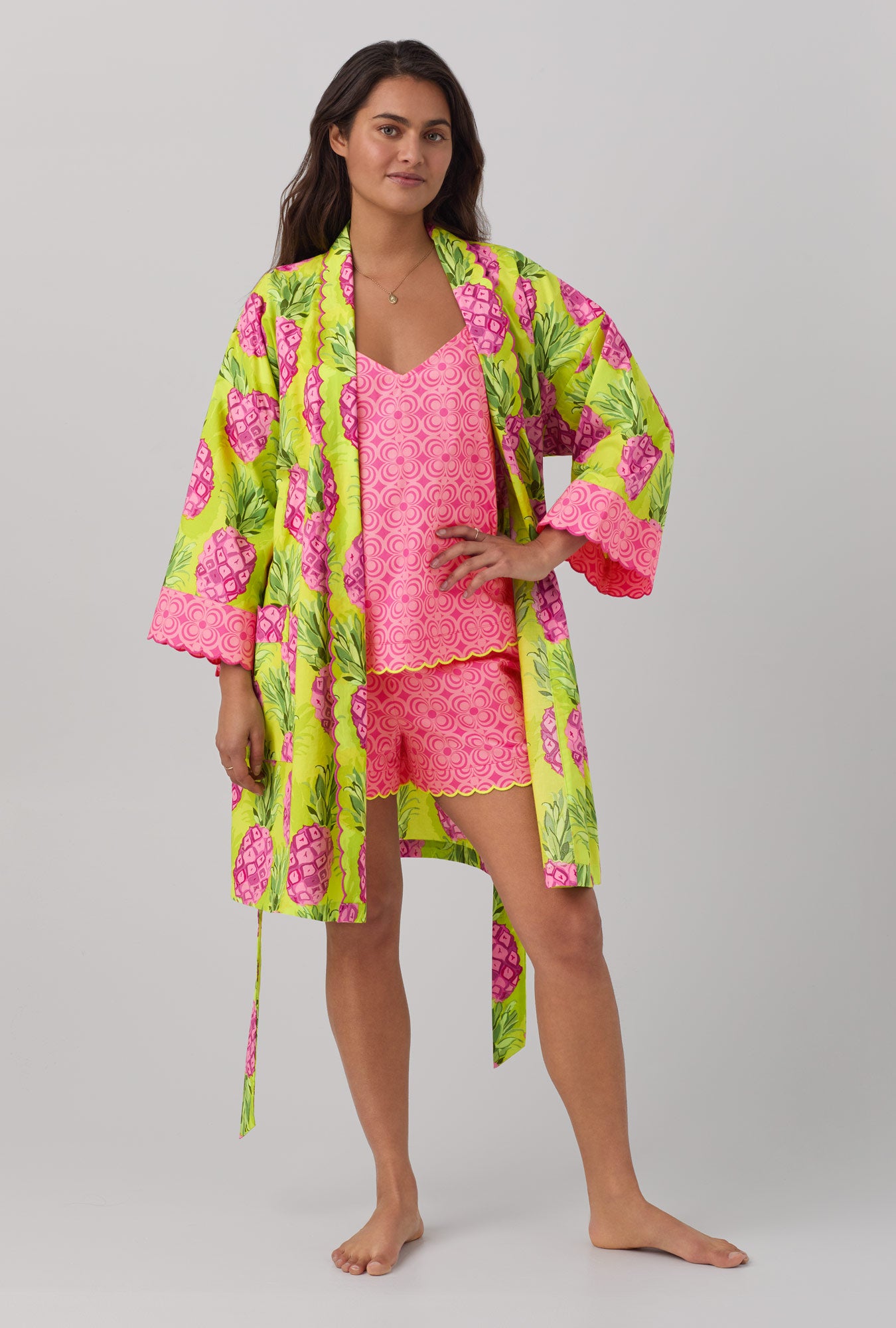 A lady wearing long sleeve woven cotton robe with kiwi pineapple print