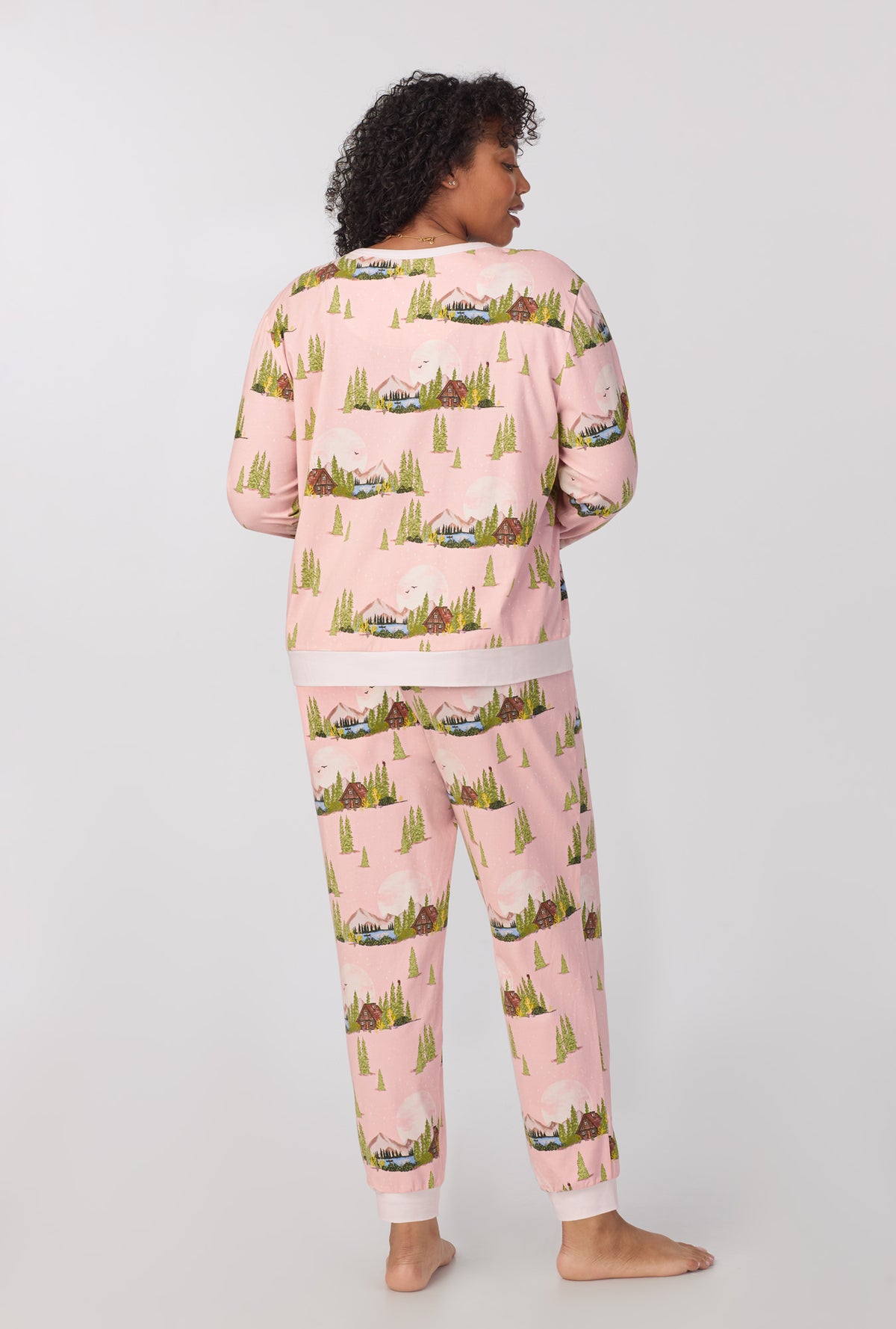 A lady wearing Long Sleeve Pullover Crew and Jogger Stretch Jersey PJ Set with Pine Lake print  