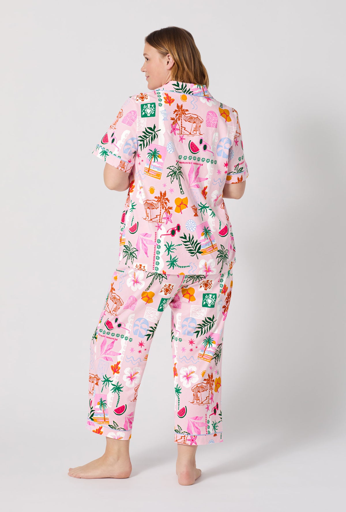 A Lady Wearing Plus Size Tropical Daydream Short Sleeve Classic Stretch Jersey Cropped Pj Set posing with a back view look