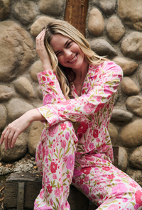 A Lady Wearing Josephine Long Sleeve Classic Stretch Jersey Pj Set in a sitting pose while touching her head with one hand