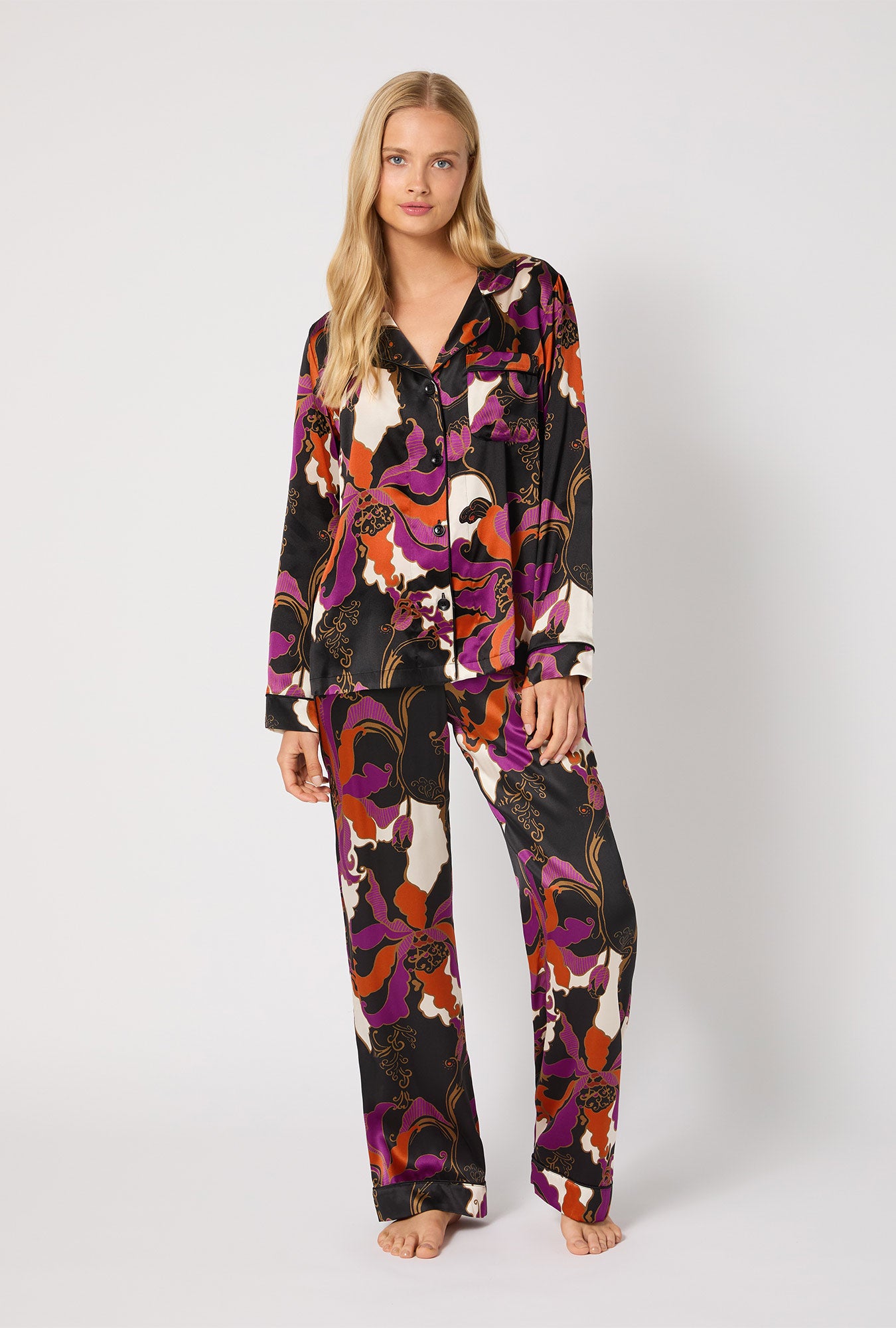 A lady wearing BedHead X Trina Turk Fall Floral Long Sleeve Classic Washable Silk PJ Set