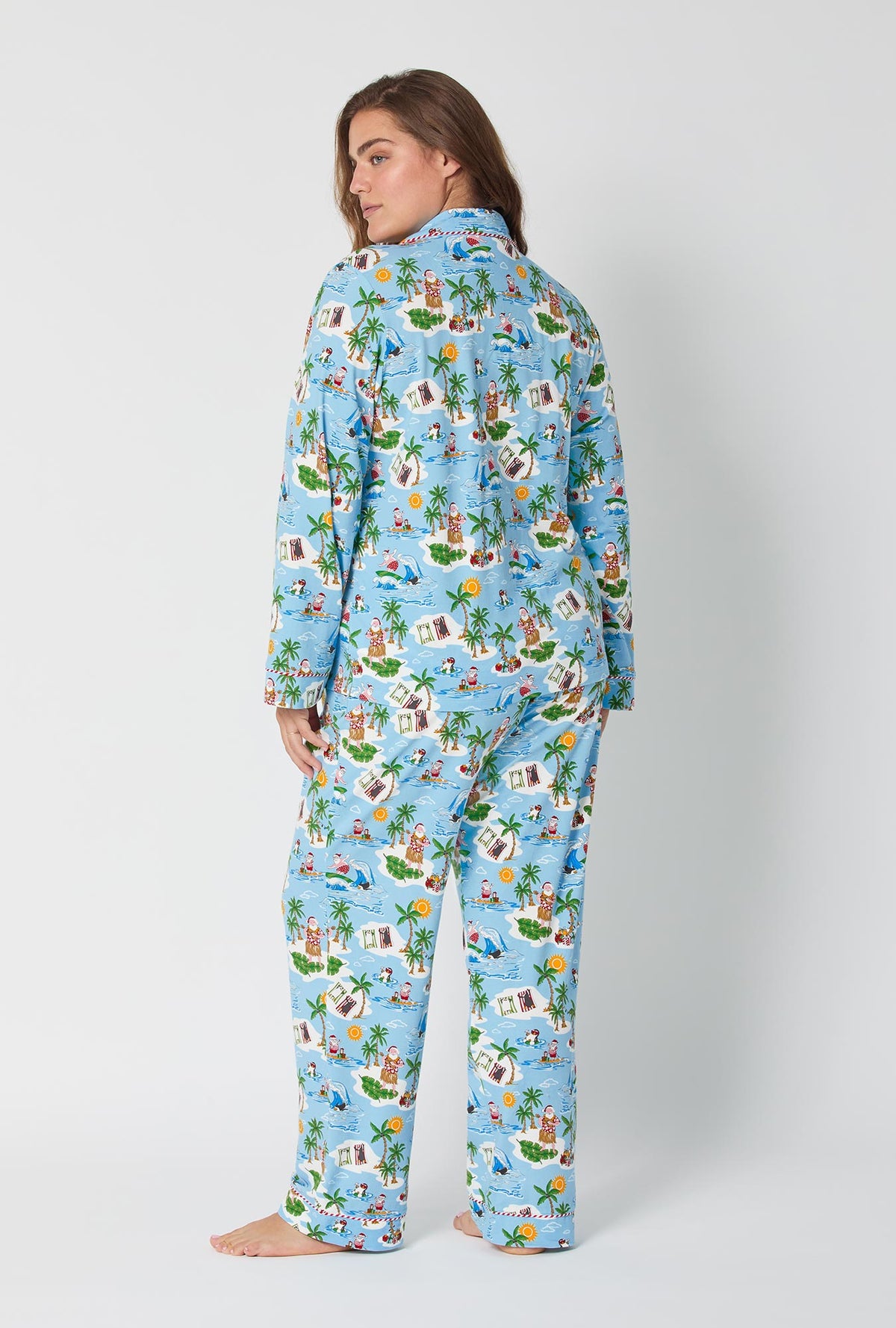 A lady wearing Surfin&#39; Santa Long Sleeve Classic Stretch Jersey Pj Set