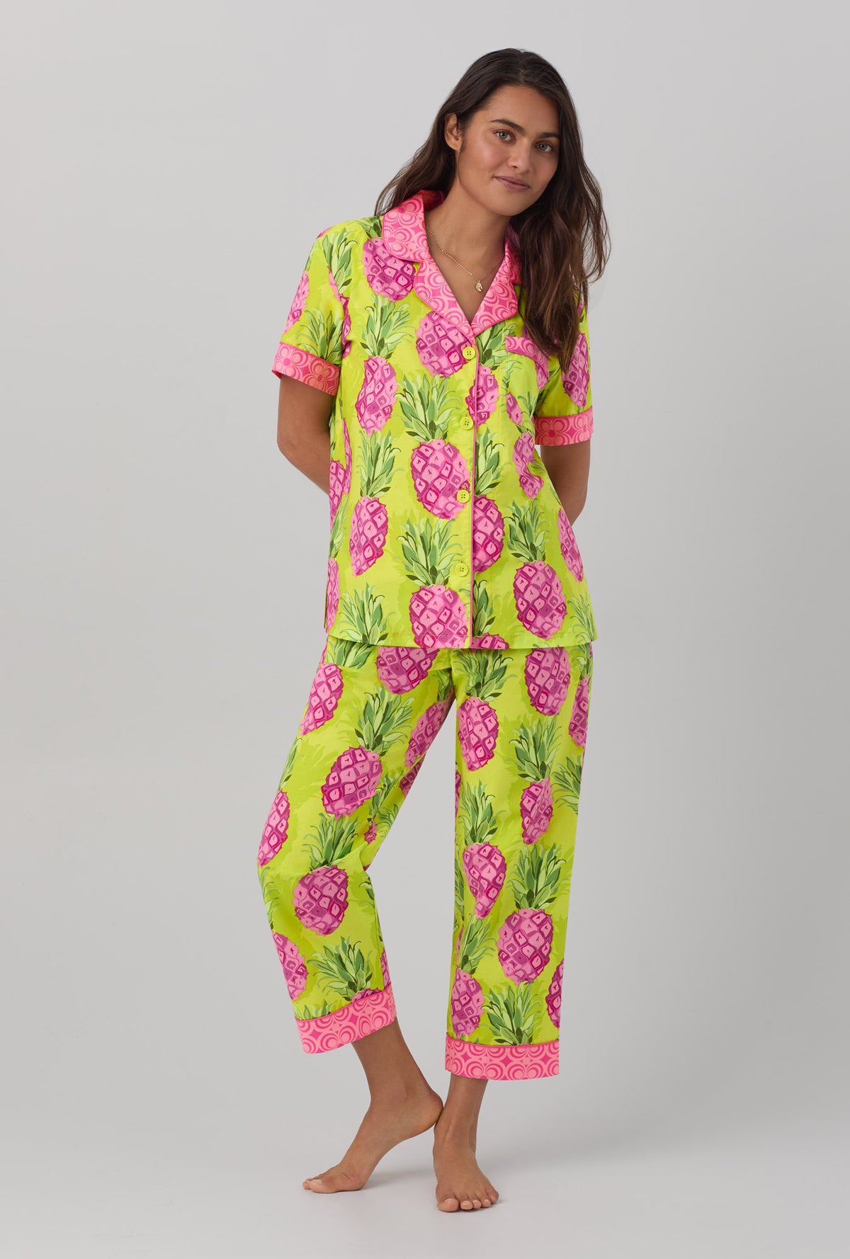 A lady wearing short sleeve classic cropped pj set with kiwi pineapple print