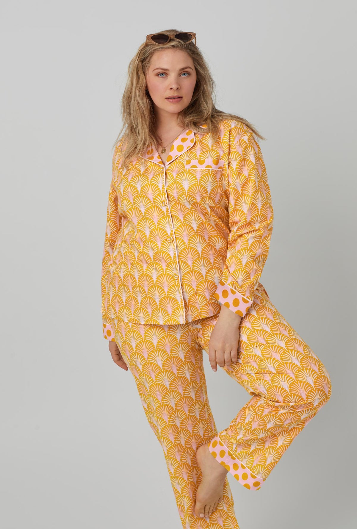 A lady wearing orange long sleeve classic woven cotton poplin pj set with suite life print