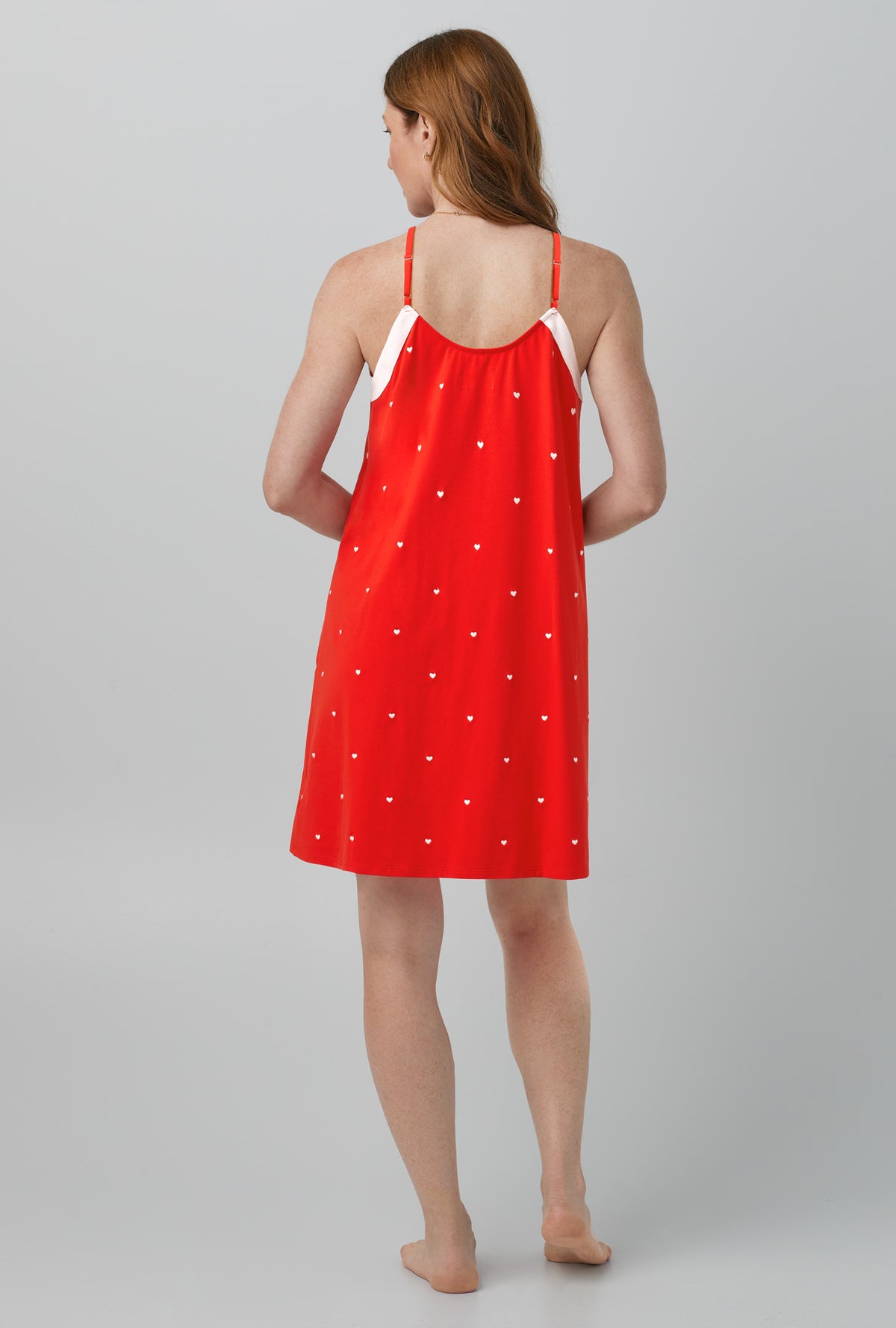 A lady wearing red chemise with tiny hearts print