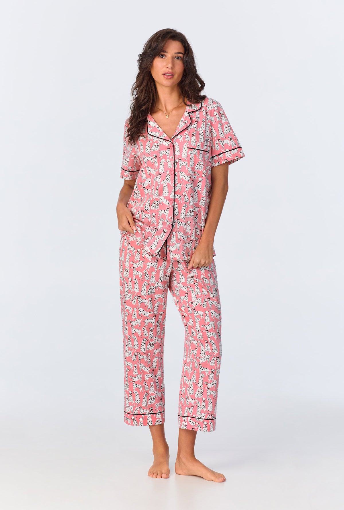 A lady wearing pink short sleeve pajama set with love spot print.