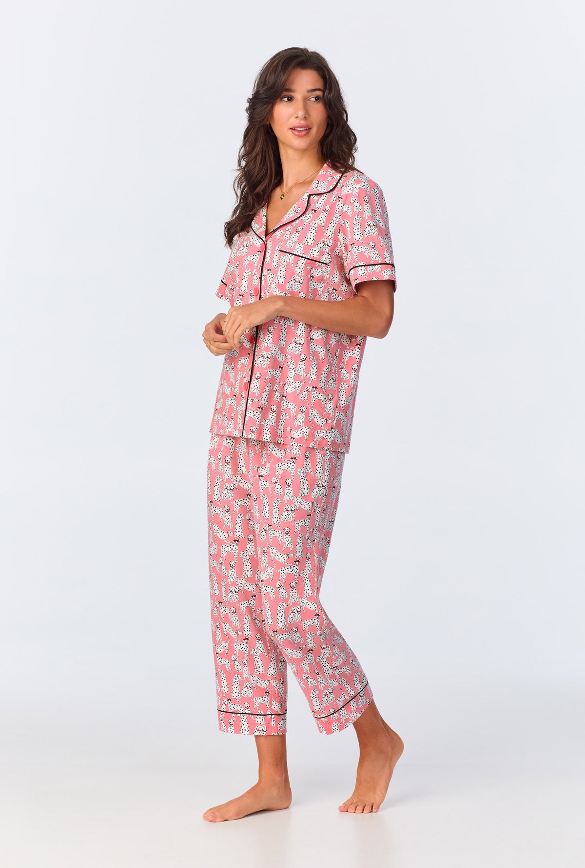 A lady wearing pink short sleeve pajama set with love spot print.