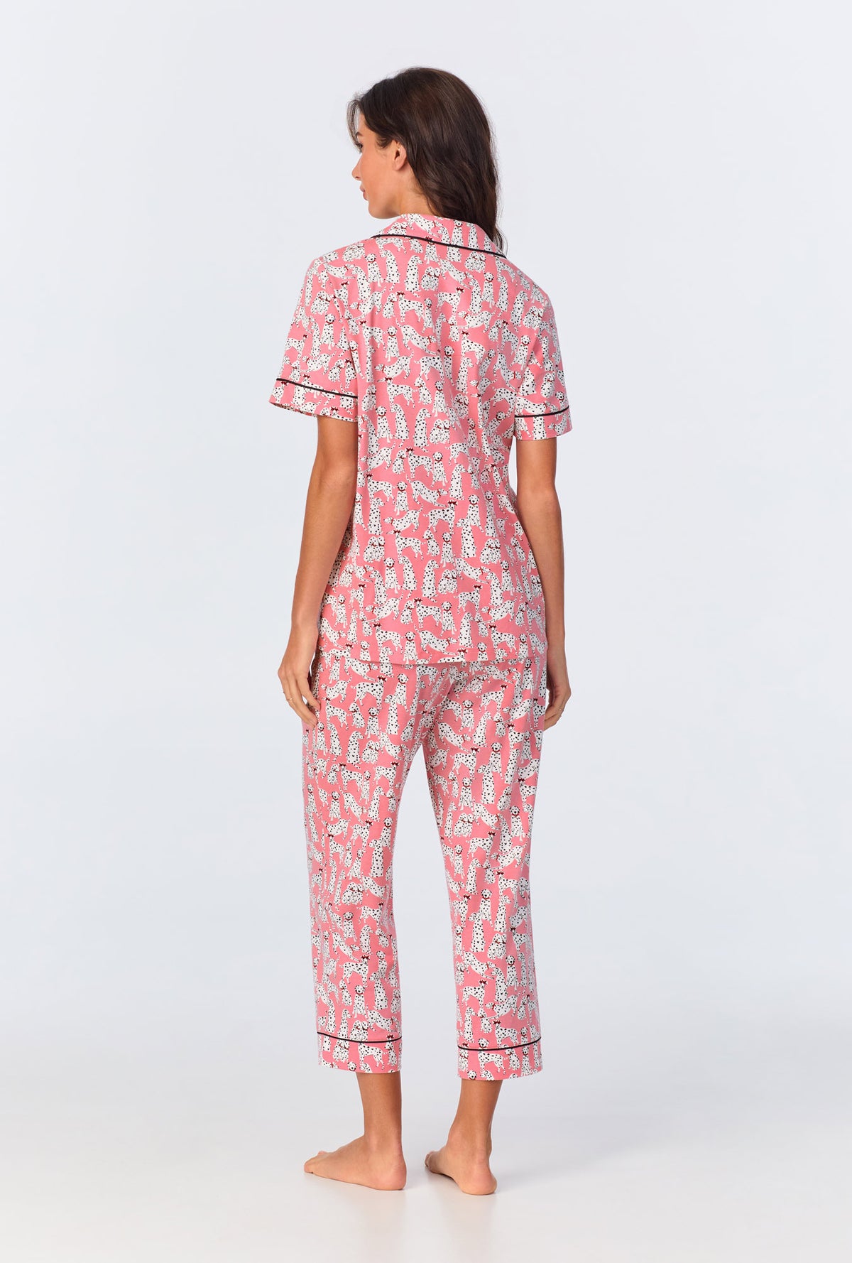 A lady wearing pink short sleeve pajama set with love spot print.