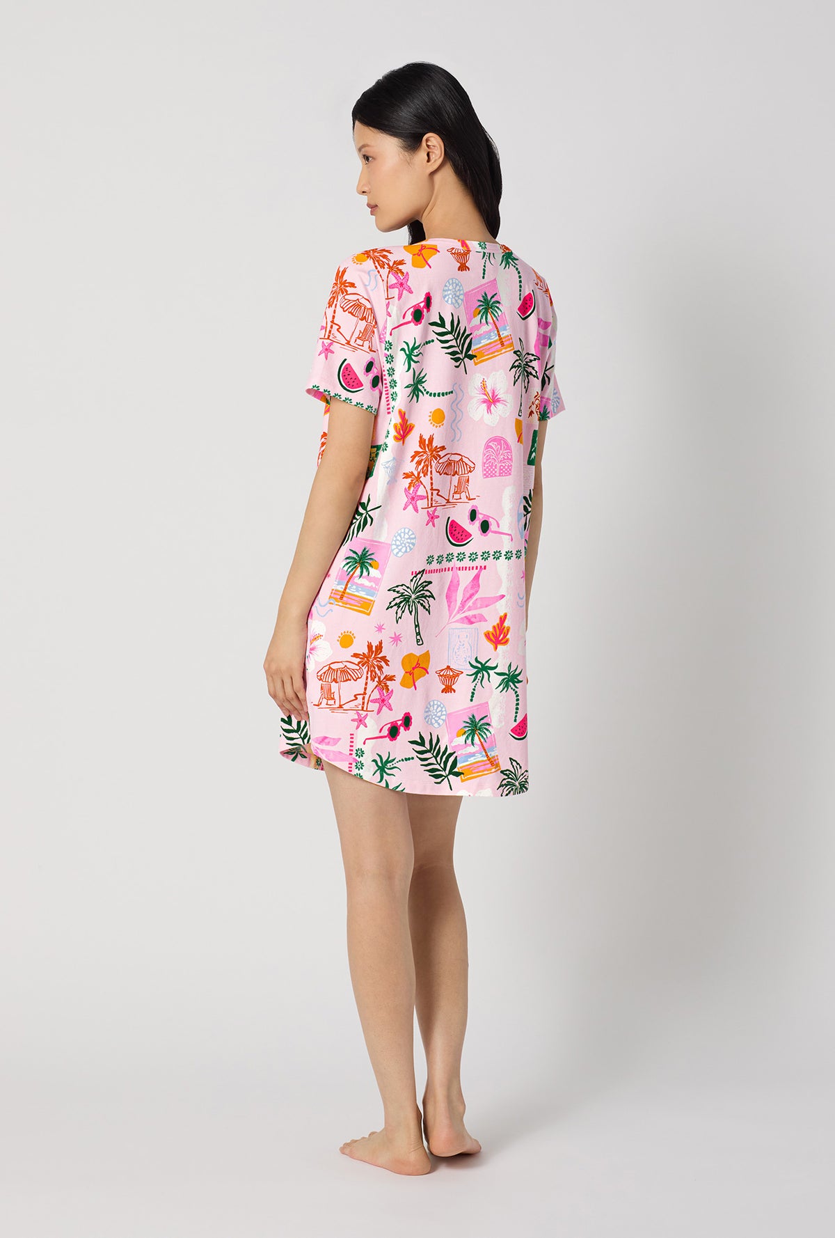 A Lady Wearing Tropical Daydream Stretch Jersey T-shirt Sleep Dress showing the back view of the dress