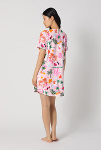 A Lady Wearing Tropical Daydream Stretch Jersey T-shirt Sleep Dress showing the back view of the dress