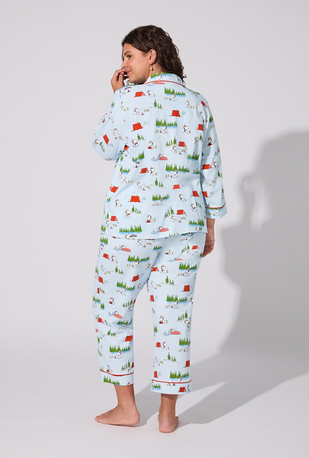 A lady wearing Peanuts® Camp Snoopy  3/4 Sleeve Classic Stretch Jersey Cropped PJ Set