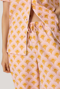 A Lady Wearing Deco Sunset Short Sleeve Classic Woven Cotton Poplin Cropped Pj Set facing front in a close up detail view