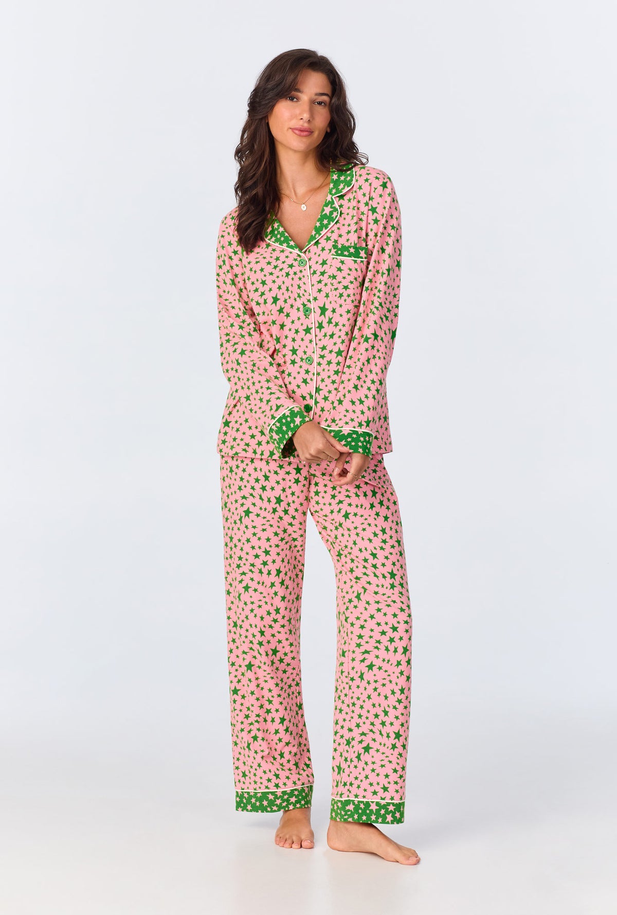 A lady wearing pink long sleeve pajama set with pink starlight print.