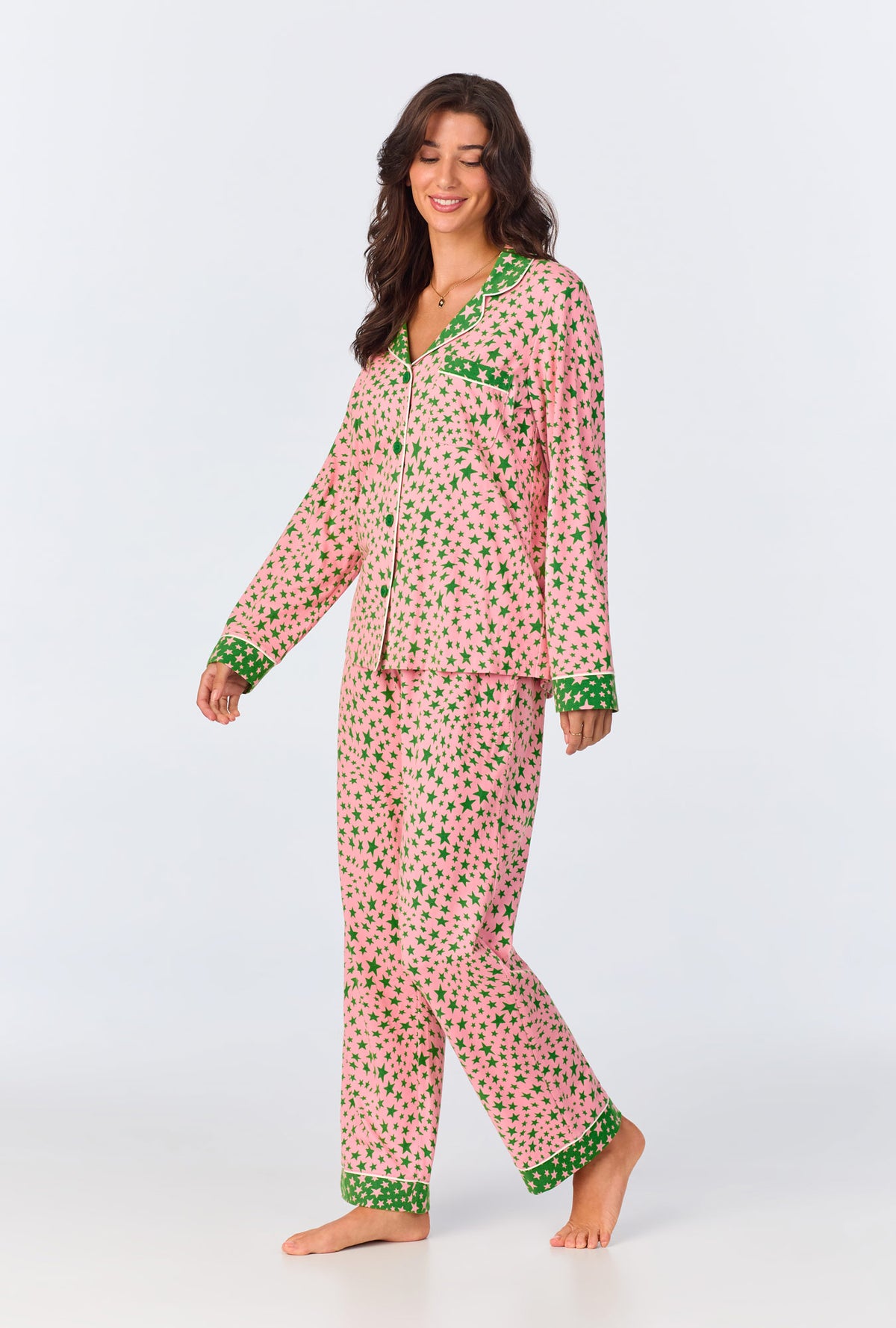 A lady wearing pink long sleeve pajama set with pink starlight print.