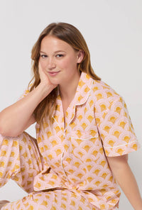 A Lady Wearing Plus Size Deco Sunset Short Sleeve Classic Woven Cotton Poplin Cropped Pj Set