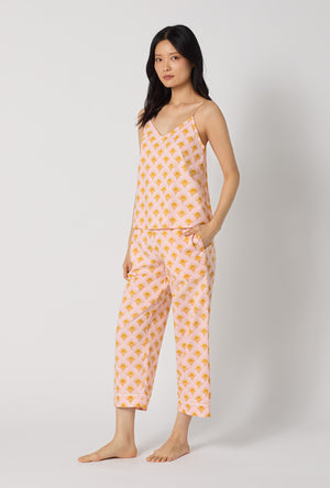A Lady Wearing Deco Sunset Cami Woven Cotton Poplin Cropped Pj Set facing front in a side angle pose